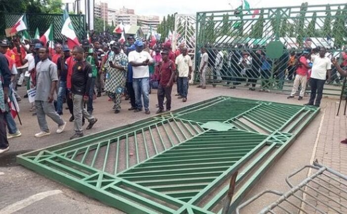 BREAKING: Protesters Pull Down NASS Gate, Take Over Premises
