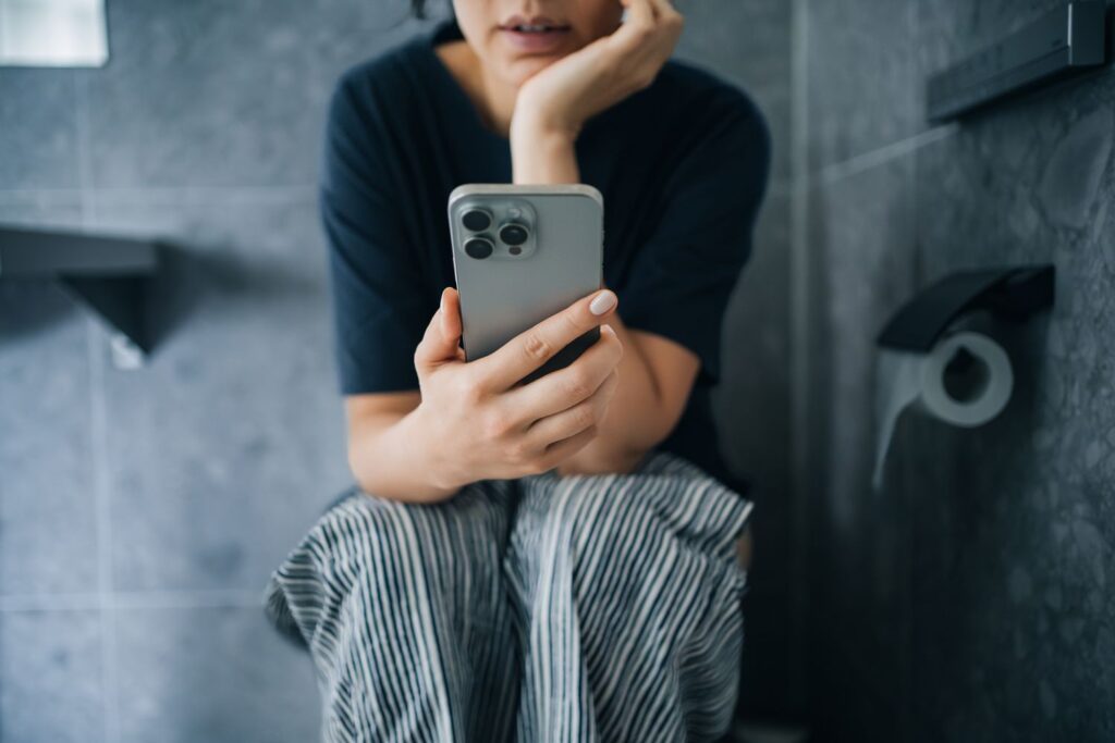 STUDY: Using Your Phone On The Toilet Could Contribute To Hemorrhoids