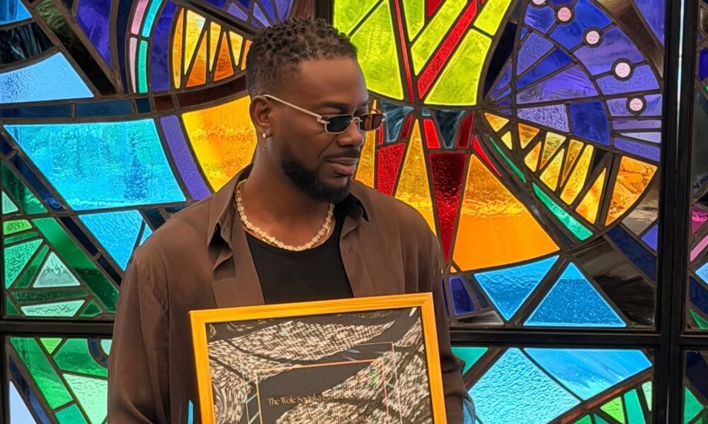 Adekunle Gold made History, receives plaque for becoming first artiste to sell out Wole Soyinka Centre